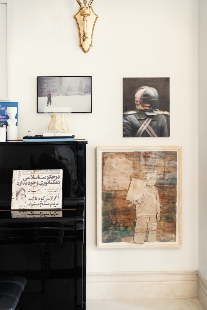 Inside Ava Ayoubi’s home: a painting by Nasser Bakhshi (top), a work by Mojtaba Amini (bottom), and a photographic piece by Mehrdad Mirzaei. On the piano lies a photo book by Maryam Zandi. Photo: Atoosa Alebouyeh