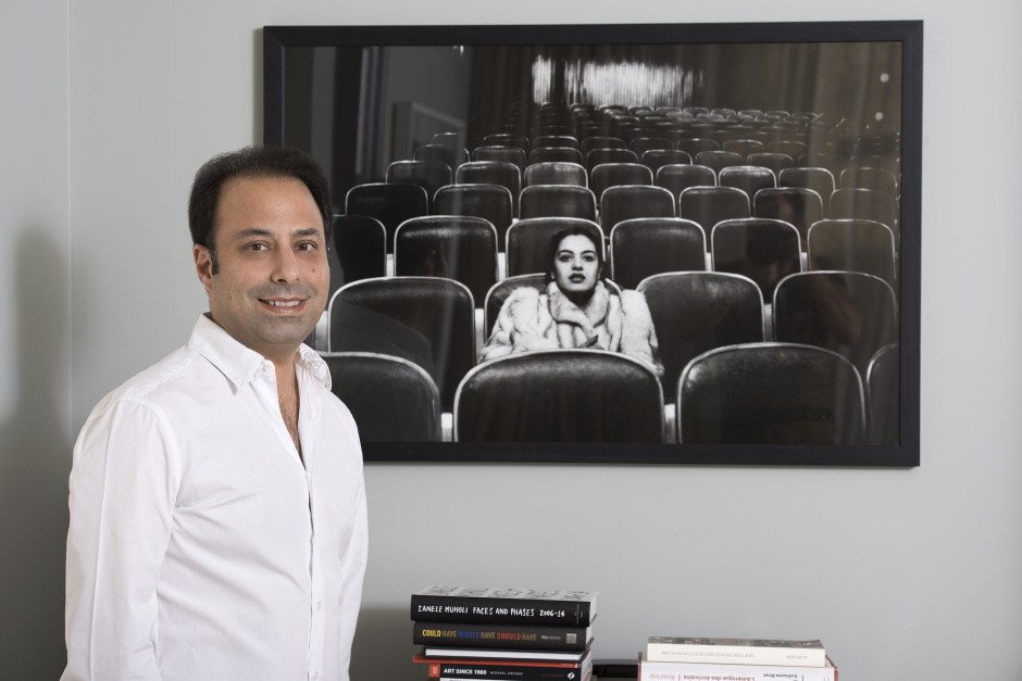 Tarek in front of a piece from his photography collection  – Fouad Elkhoury: Sherihan, Egyptian Cinema, 1985 – 1990, Cairo, 1987. Courtesy of Tarek Nahas.