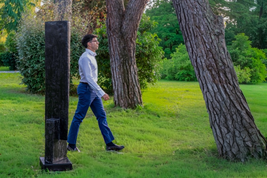 Giuseppe with a sculpture by Beverly Pepper. Courtesy of Giuseppe Simone Modeo