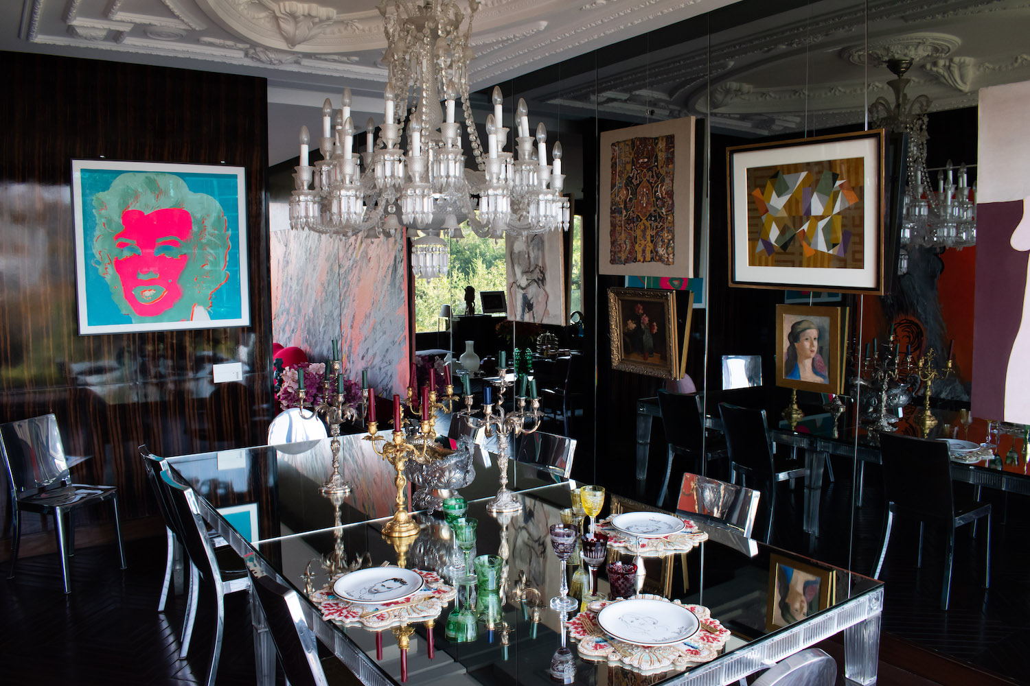 Andy Warhol, “Marilyn (F&S 30)”; Grace Weinrib, “Pencil (triptych) (partially seen in the back room); Enrique Castro Cid, “Untitled”; and Josefina Guilisasti, “Fragmento Persa S XVII”; Matilde Pérez, “Flores” and “Untitled”; Graciela Aranis, “Untitled”; Roser Bru, “Los Tiempos Han Cambiado” (partially seen on right side of image); Philippe Starck Emeco Hudson Chairs; Baccarat dinning table by Philippe Stark; and Baccarat chandelier Philippe Starck. Photo: Andrés Herrera. Courtesy of Juan Yarur.
