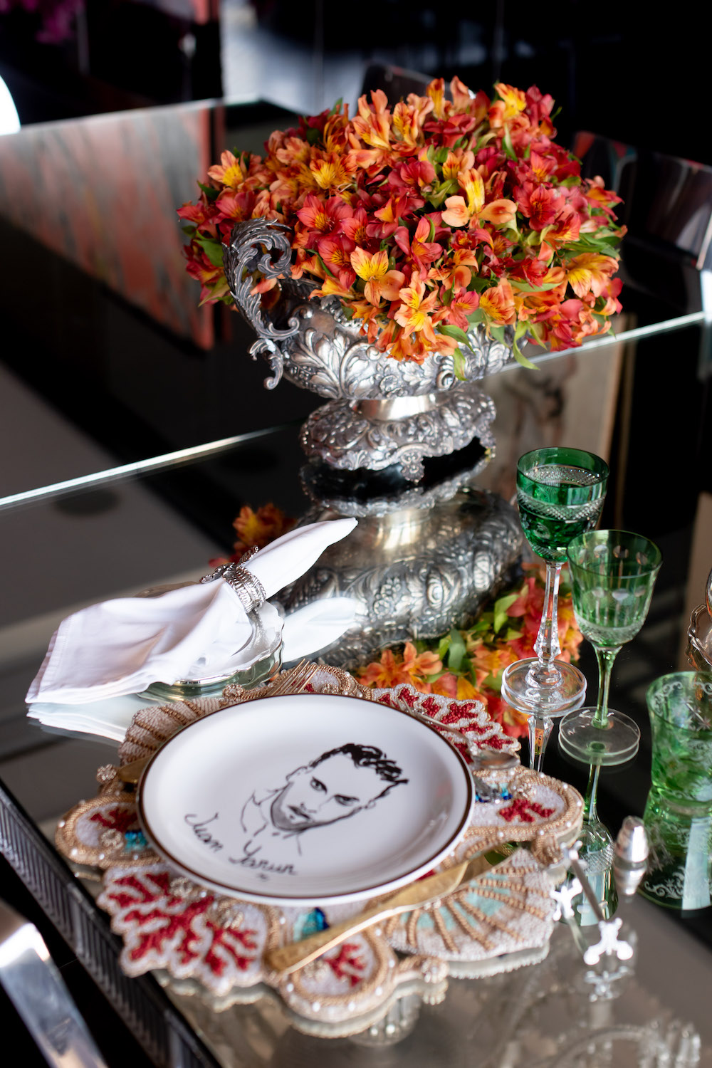 Dishes on table hand made with illustrations by Manuel Santelices; Philippe Starck Emeco Hudson Chairs; and Baccarat dinning table by Philippe Stark. Photo: Andrés Herrera. Courtesy of Juan Yarur.
