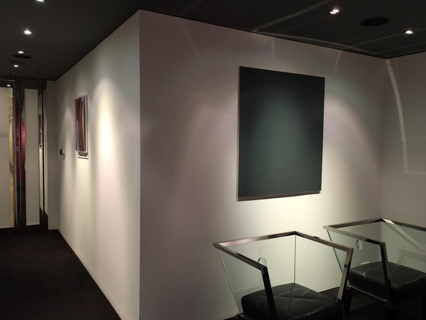 Wolfgang Tillmanns, "Lighter VI", 2007 (left) and Gerhard Richter, "Mirror, Grey (739-2)", 1991 (right), in Kazunari Shirai's office in Hong Kong. Courtesy of Kazunari Shirai.