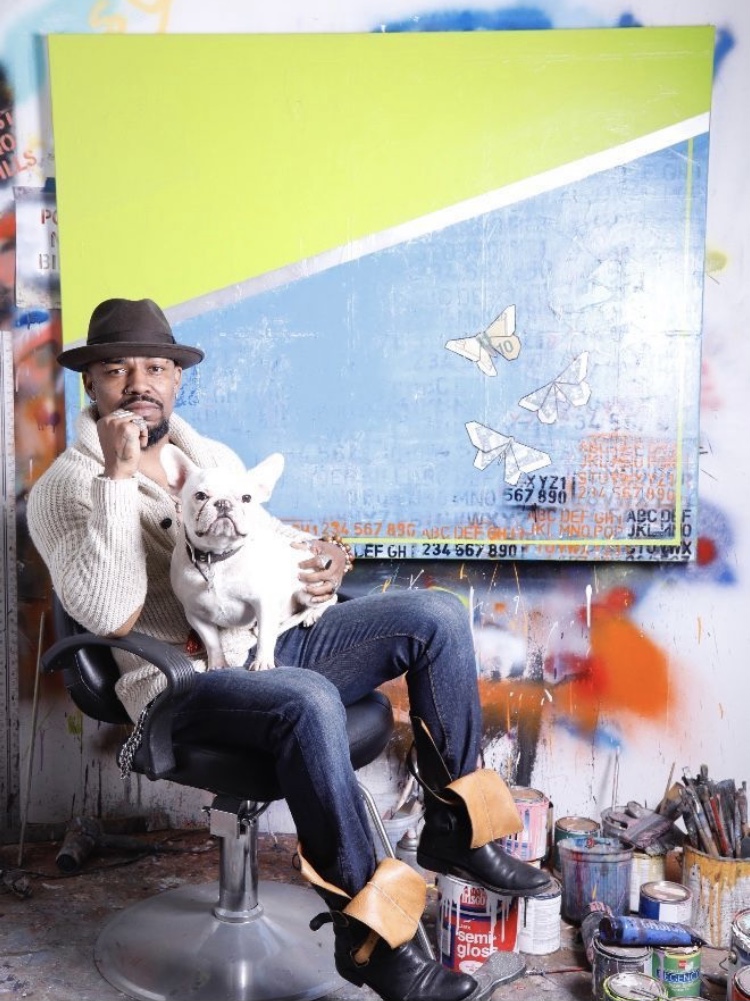 Guy Stanley Philoche with his dog Picasso in his studio. Courtesy of Guy Stanley Philoche.