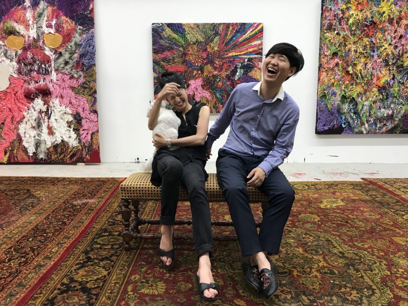 Hong Gyu Shin and art professional Masako Shiba. Background: paintings by Hyon Gyon. Courtesy of Hong Gyu Shin.