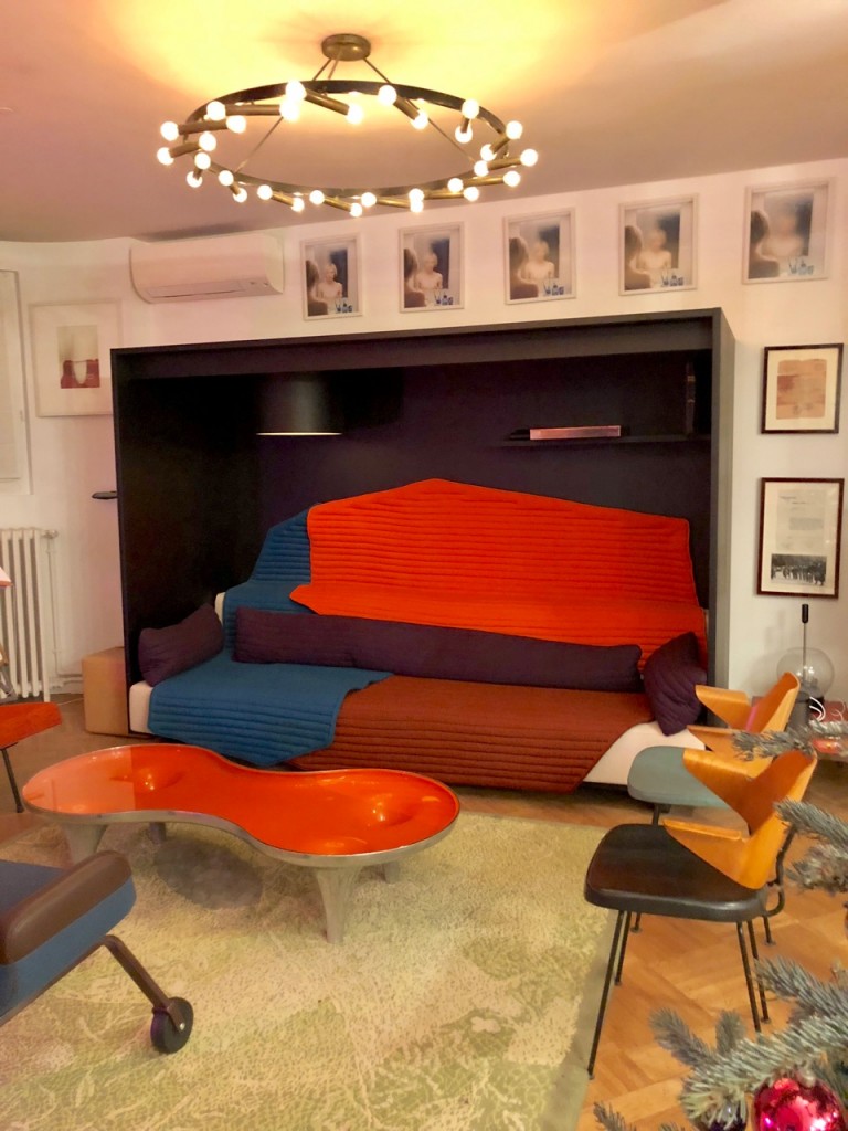 Rug by Fabrice Hyber; along with various design pieces: sofa by Ronan & Erwan Bouroullec, coffee table by Marc Newson, U.N. chairs by Hella Jongerius, chairs by Robin Day, ceiling light by Gino Sarfatti. Courtesy of Clémence and Didier Krzentowski.