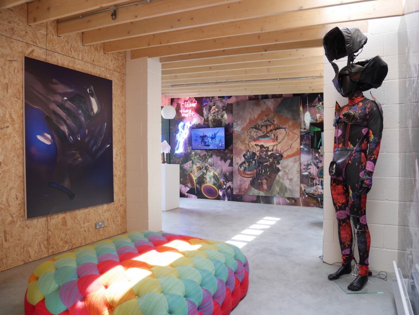 Digital painting by Luisa Gagliardi, lamp by Cary Kwok, neon light, wallpaper, video and digital print by Jacolby Satterwhite, costume with video by Jacolby Satterwhite (left to right). Courtesy of Victor Benady.