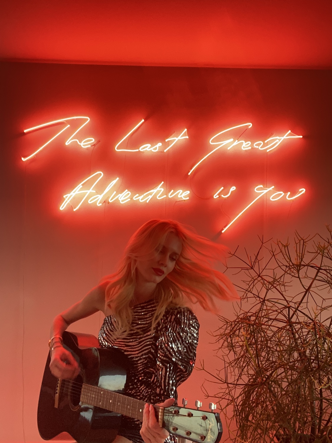 Celesta in front of her very first art piece. Tracey Emin, “The Last Great Adventure is You”, 2014. Courtesy of Celesta Hodge. 