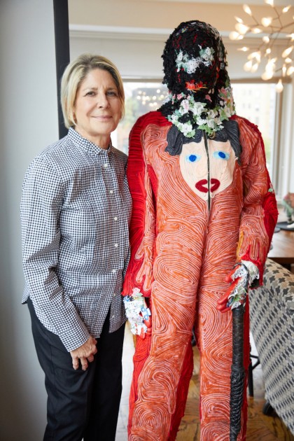 Eileen next to an artwork - Raul de Nieves, Celebratory Skin - Blue God, 2016. Courtesy of Eileen and Richard Ekstract.