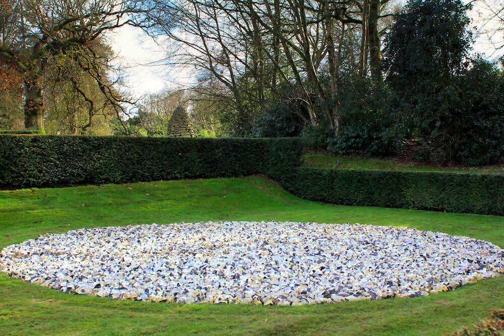 Richard Long’s “Red Kite Circle” constructed by the artist at Miel de Botton’s country home in 2009.  The work is 8m in diameter and made of Wessex flints.  Goldsworthy’s oak cairn can be seen in the background, courtesy of Miel de Botton.