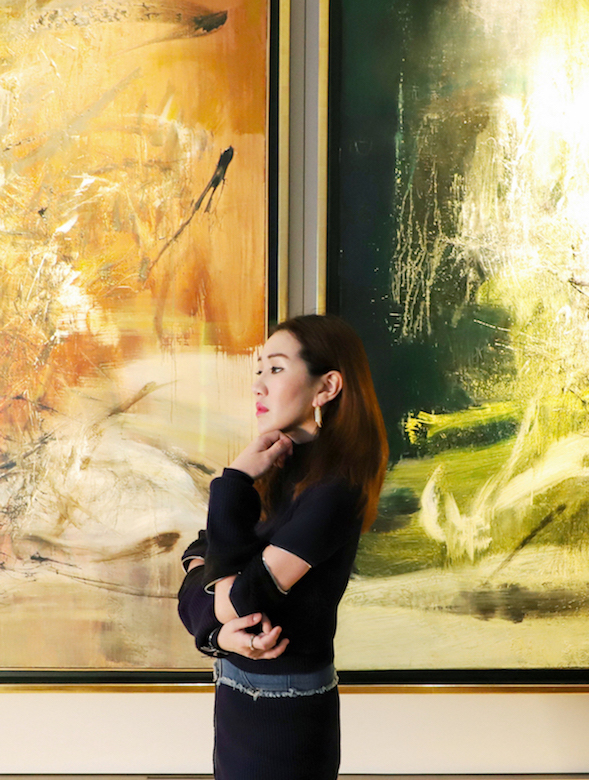 Sabrina Ho with two works by Zao Wou-ki. On the left is 16.5.66 (1966) and on the right 3.4.60-1.2.69 (1960-69). Courtesy of Sabrina Ho.