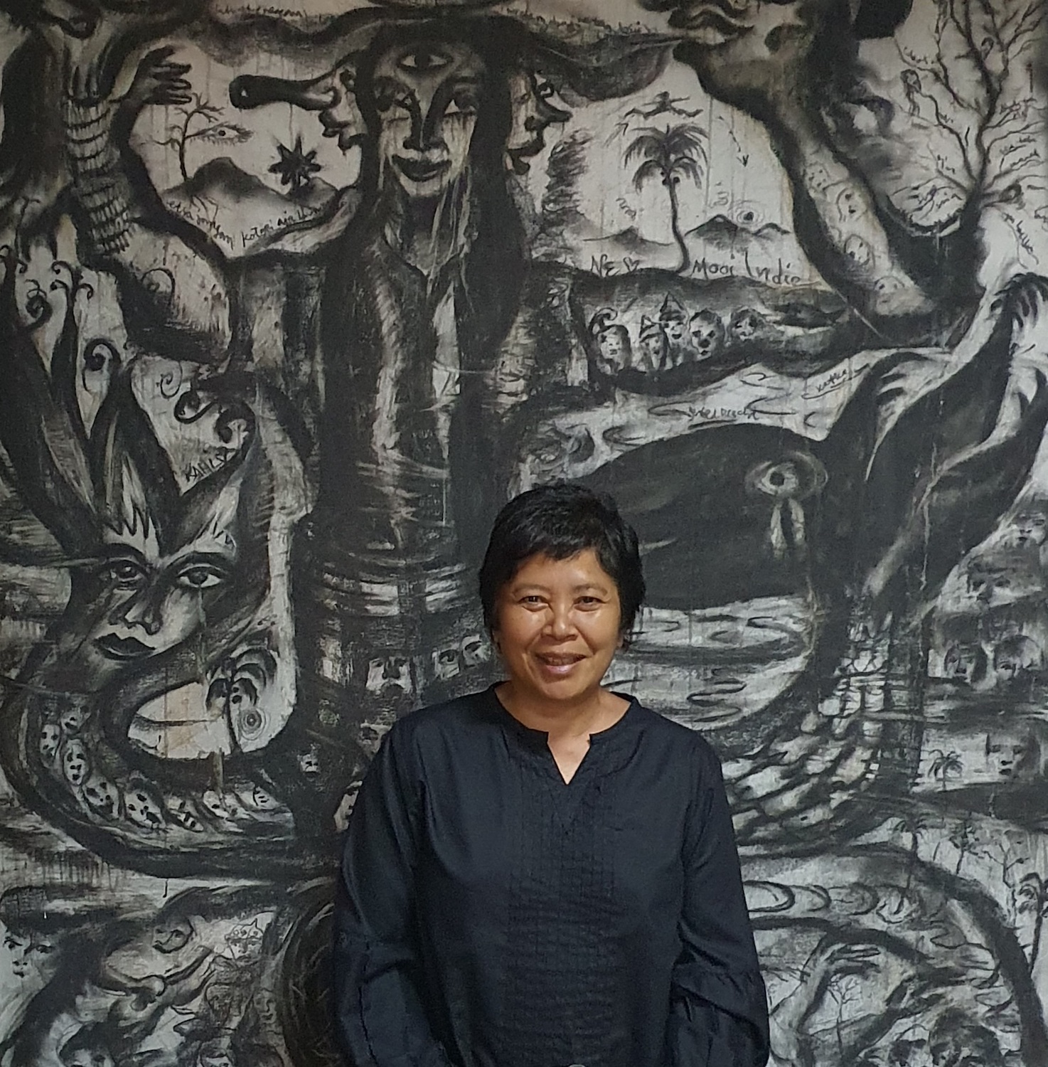 Andonowati at home with a work by Tisna Sanjaya in the background. Courtesy of Andonowati. 