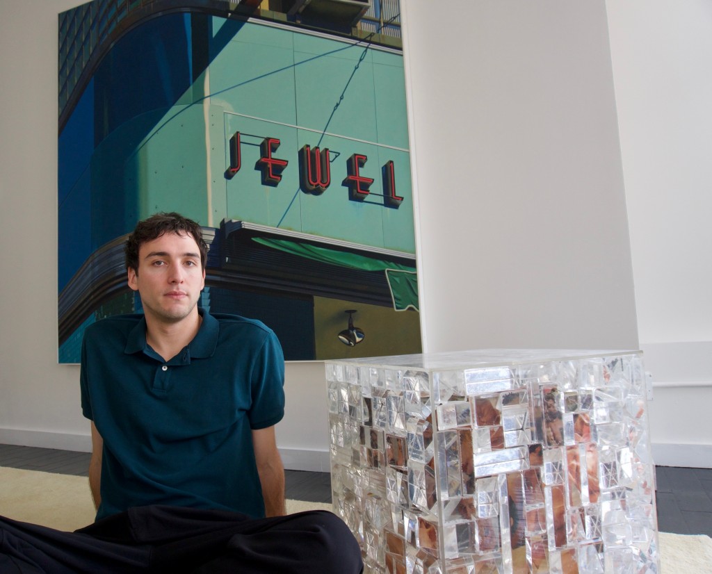 Portrait of Zacharie Vallois in front of "Jewel" by Robert Cottingham and near "Homage to Elizabeth Taylor" by Arman